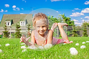 Little adorable girl playing with white Easter