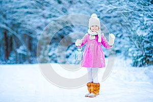 Little adorable girl with in winter day outdoors