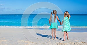 Little adorable girls enjoy summer beach vacation