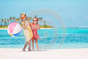 Little adorable girls playing with air ball on the beach. Kids having fun on the seashore