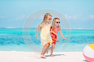 Little adorable girls playing with air ball on the beach. Kids having fun on the seashore