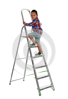 Little African-American boy climbing up ladder on background. Danger at home