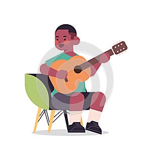 Little african american boy playing guitar childhood concept full length isolated