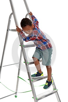 Little African-American boy  up ladder on white background. Danger at home