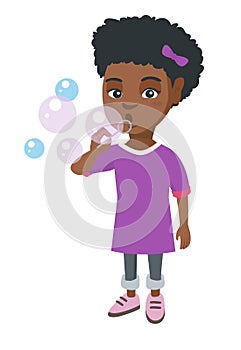 Little african-american girl blowing soap bubbles.