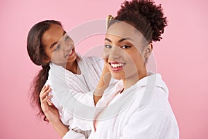 Little African American girl is combing mother