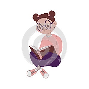 Little African American girl with glasses sits and reads a book. Concept back to school and study. Schoolgirl with glasses is