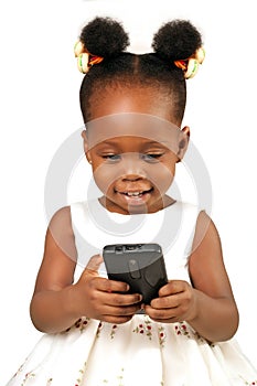 Little girl smiling at a mobile phone