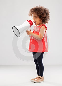 Little african american girl shouting to megaphone