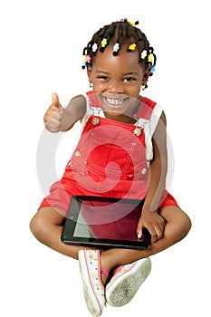 Little African American girl using tablet pc