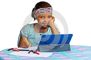 Little African American sitting with tablet at desk