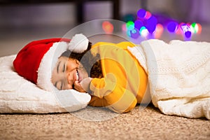 Little african angel sleeping under Xmas tree