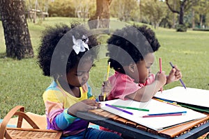 Little african boy and girl playing in backyard