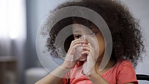 Little African girl drinking still mineral water liquid balance in body, closeup