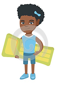 Little african girl holding inflatable mattress.