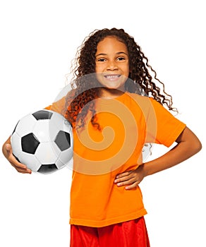 Little African girl holding soccer ball isolated