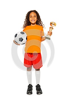 Little African girl holding soccer ball and prize