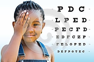 Little african girl testing eyesight.