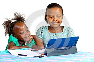 Little african girls looking together at tablet