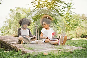 Little child reading with friend photo
