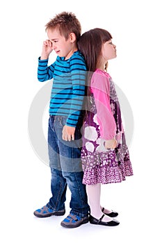 Little aggrieved boy standing near girlfriend photo