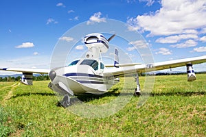 Little airplane on green grass field