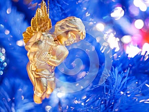 little angel Christmas hanging decoration on blue background