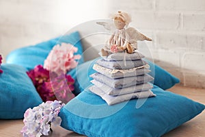 Little angel doll sitting on a pillow. Valentine`s day. Children`s toy hand made