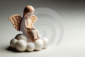 A little angel sitting on a cloud. Space for text.