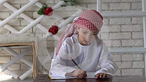 Little arabic boy studying at school.