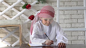 Little arabic boy studying at school.