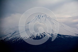 Little Ararat is covered in snow. Clouds over Mount Ararat