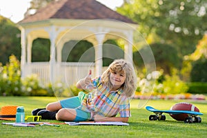 Little artist drawing painting art in park. Child drawing picture with crayon in summer park outdoor. Happy little kid