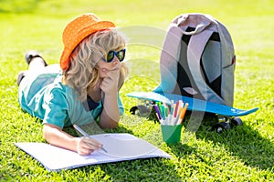 Little artist drawing painting art in park. Kid boy create artist paints, summer vacation. School child drawing in