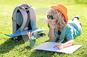 Little artist drawing painting art in park. Kid boy create artist paints, summer vacation. School child drawing in