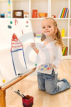 Little artist girl painting her dream house