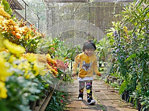 Little Asian baby girl enjoys walking in a flora garden - engaging with nature provides positive impact