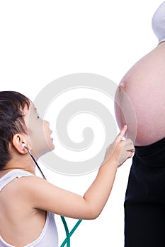 Little asian boy examining pregnant mother's tummy photo