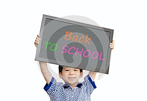 Little Asian boy holding chalkboard over white background