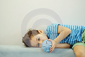 Little asian boy holds a piggy bank in his hands. money saving concept