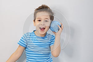 Little asian boy holds a piggy bank in his hands. money saving concept