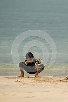 Little asian boy playing on the beach.Vacation and relax concept