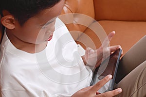 Little Asian Boy Playing Tablet