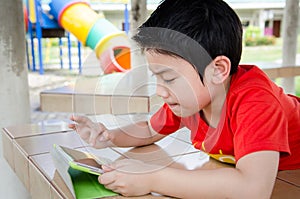 Little asian boy smiles with tablet computer