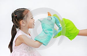 Little Asian child girl hands playing animal puppets with hand of her mother on white background. Educations concept