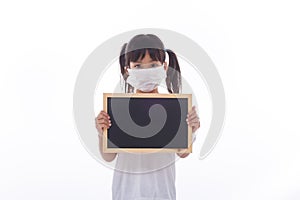 Little Asian child show the black board on isolated background