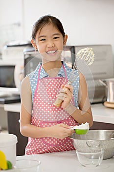 Little Asian cute chef cooking a bakery in kitchen