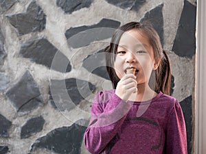 Little Asian girl eating ice cream