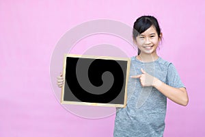 Little asian girl holding blackboard.