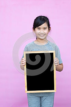 Little asian girl holding blackboard.